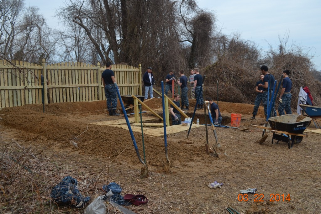 Midshipmen cleaning out the previously dug Education Soil Health Pit