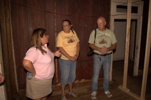 (Left to right) Cathy Vitale and Kay Himmelman get a tour of the house from Roy Benner